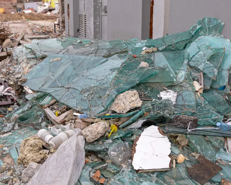 Broken glass and building debris waiting for rubbish removal in Bristol