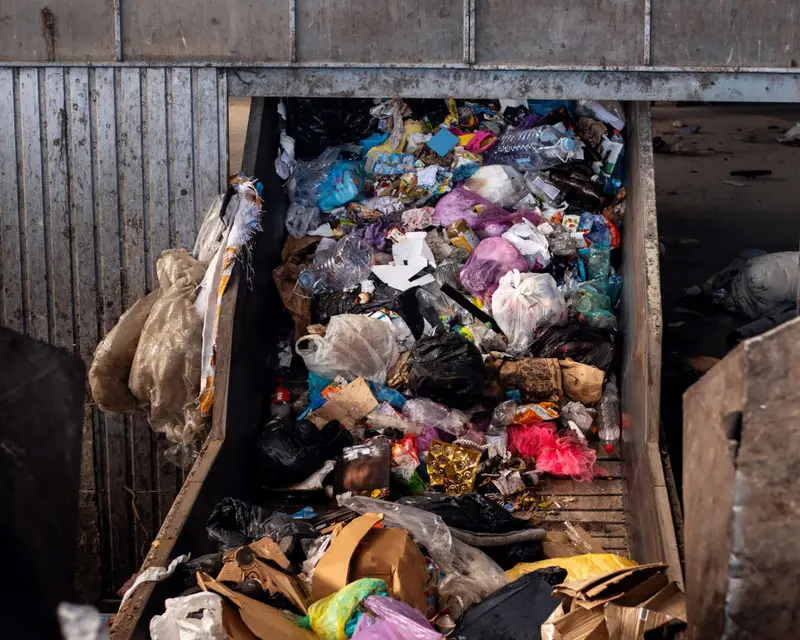 Commercial waste on a sorting conveyor after collection