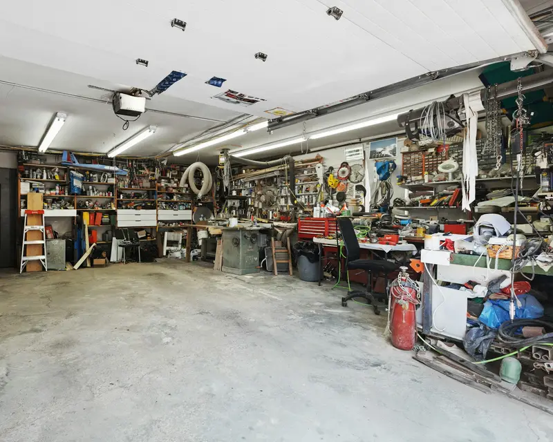 Garage full of tools and clutter before a garage clearance by Waste Bristol